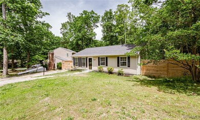 Ranch-style home featuring a front lawn