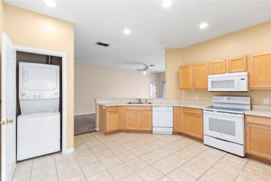 Stackable washer & dryer closet in the kitchen