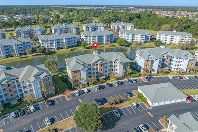 Aerial view of property's location featuring apartment complex / building and a large body of water