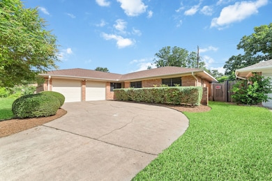 The spacious rounded driveway leads to a two-car a