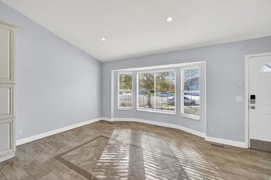 Entrance foyer featuring recessed lighting, lofted ceiling, and light wood-style floors