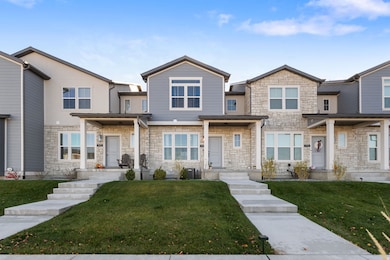 View of front facade with stone siding and a front yard