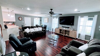This spacious bright living area features rich har