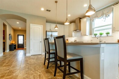 Kitchen featuring decorative backsplash, wall chim