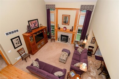 The foyer leads to the two story great room with a fireplace.