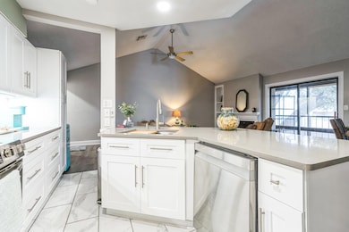 Kitchen featuring visible vents, lofted ceiling, 