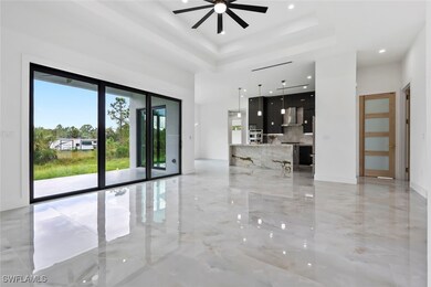 Empty room featuring a ceiling fan, light marble f