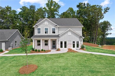 View of front facade with french doors, board and batten siding, a front lawn, and a shingled roof