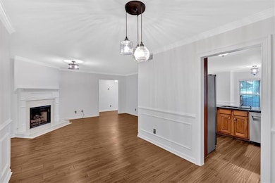 Unfurnished living room with ornamental molding, a