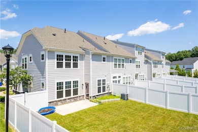 Rear view of house with a patio, a fenced backyard