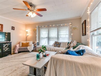 Bedroom featuring ceiling fan and ornamental moldi