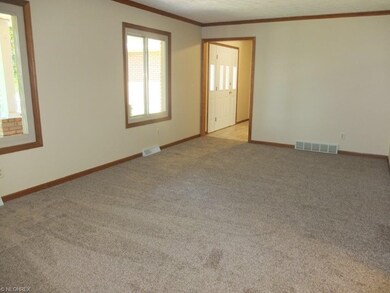 Spacious great room with crown molding and new car