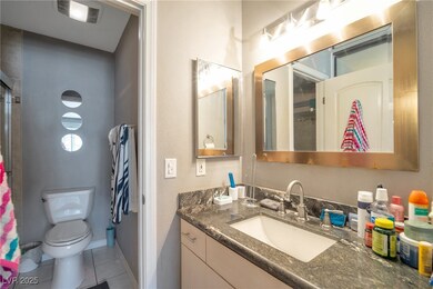 Bathroom featuring toilet, tile patterned floors,