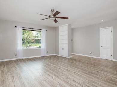 Unfurnished room with a ceiling fan, light wood-s