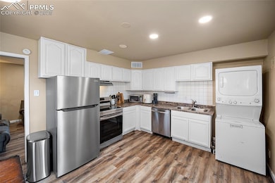 Kitchen featuring stainless steel appliances, stac