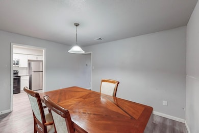 Dining area featuring baseboards, visible vents, a