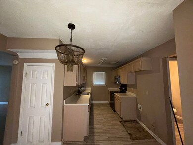 Kitchen featuring a textured ceiling, sink, an inv