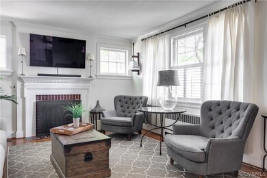 Beautiful mantel flanked by high craftsman style windows.