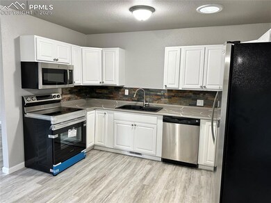 Kitchen with stainless steel appliances, a sink, w