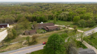 Aerial view featuring a wooded view
