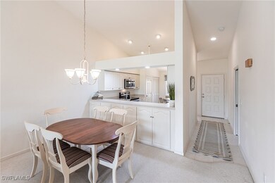 Dining room with high vaulted ceiling, carpet, and
