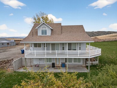 Rear view of house with roof with shingles, a patio area, and a yard