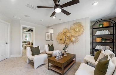 Carpeted loft with  ceiling fan