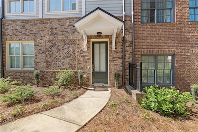 Entrance to property featuring brick siding