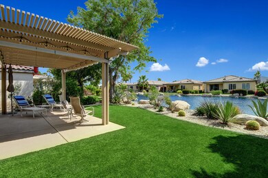 BACK YARD TO TRELISSED PATIO AND LAKE