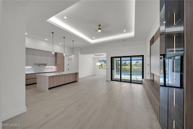 Unfurnished living room featuring a raised ceiling