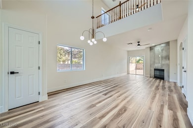 Unfurnished living room featuring baseboards, ligh