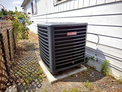 Exterior view of a cooling unit and board and batten siding