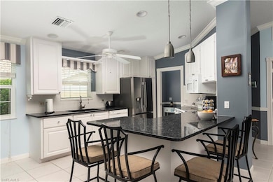Kitchen featuring stainless steel fridge with ice 