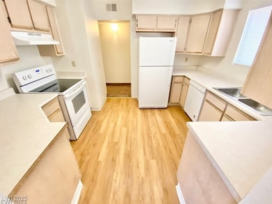 Kitchen with white appliances, under cabinet range