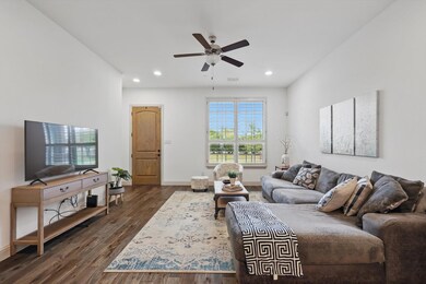 Living room with a ceiling fan, recessed lighting,