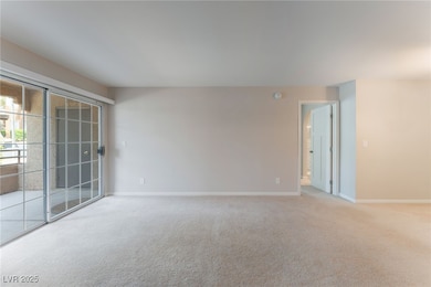 Spare room with light colored carpet and baseboard