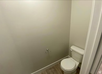 Bathroom with baseboards and wood finished floors
