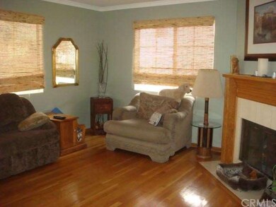 Living room with cozy fireplace, hardwood flooring