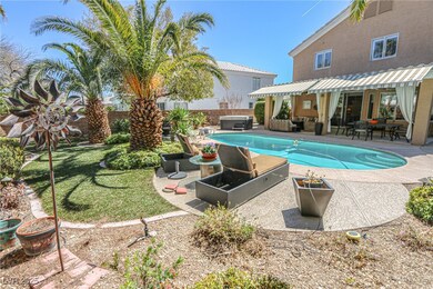 View of pool with a jacuzzi, a fenced backyard, a