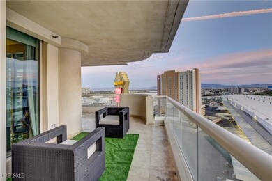 Balcony at dusk featuring a view of city