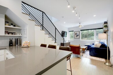 Dining room with stairway, ceiling fan, light woo