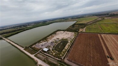 Aerial overview of property's location with a nearby body of water and rural landscape