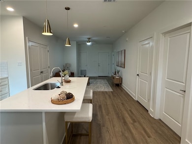 Kitchen featuring dark wood finished floors, hangi
