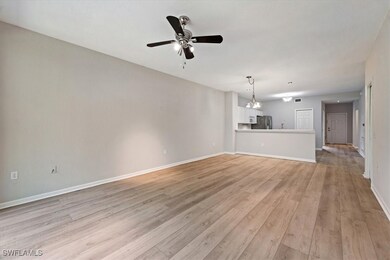 Unfurnished living room with a ceiling fan and lig