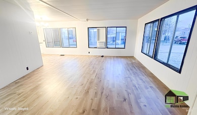 Empty room featuring hardwood / wood-style floors, wood walls, a chandelier, and cooling unit