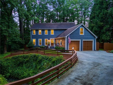 Colonial home with driveway and an attached garage