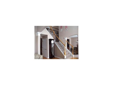 Dramatic staircase with wrought iron spindles