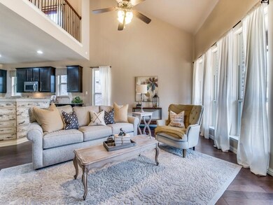 famly room features a vaulted ceiling and multiple