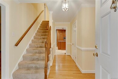 Foyer with hardwood floors, chair rail, crown mold