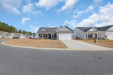 Craftsman inspired home featuring brick siding, driveway, and a garage